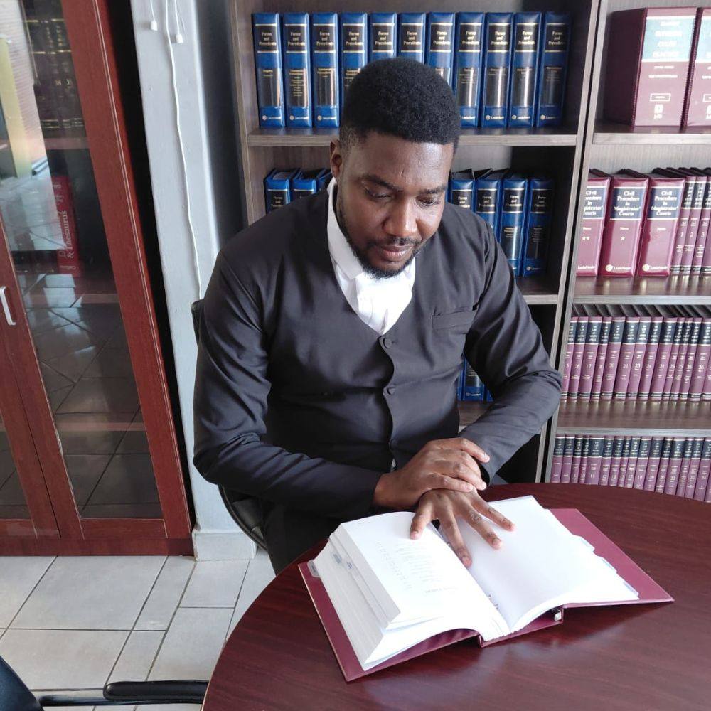 Calvin Manganye researching in the law library
